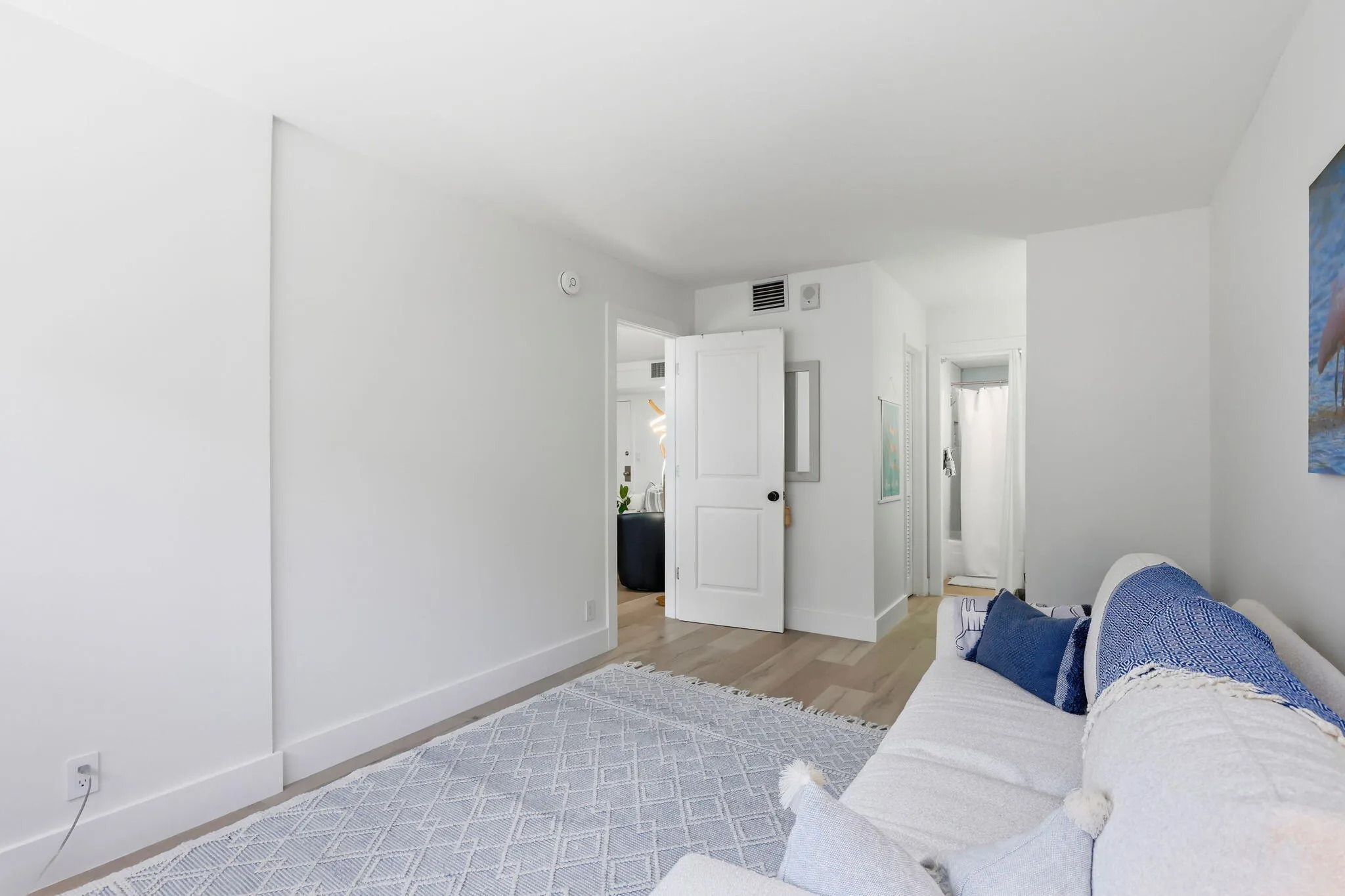 Neutral white walls complement light wood look finish flooring