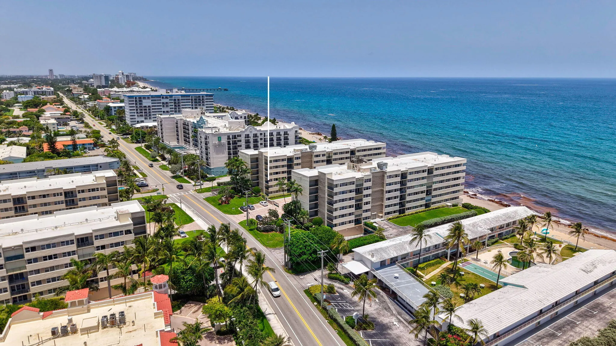 Coastal multi-story residential buildings featuring balconies and expansive ocean frontage