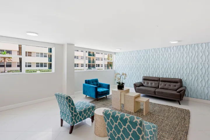 Spacious common area featuring a textured accent wall, recessed lighting, large windows bringing the outside in!