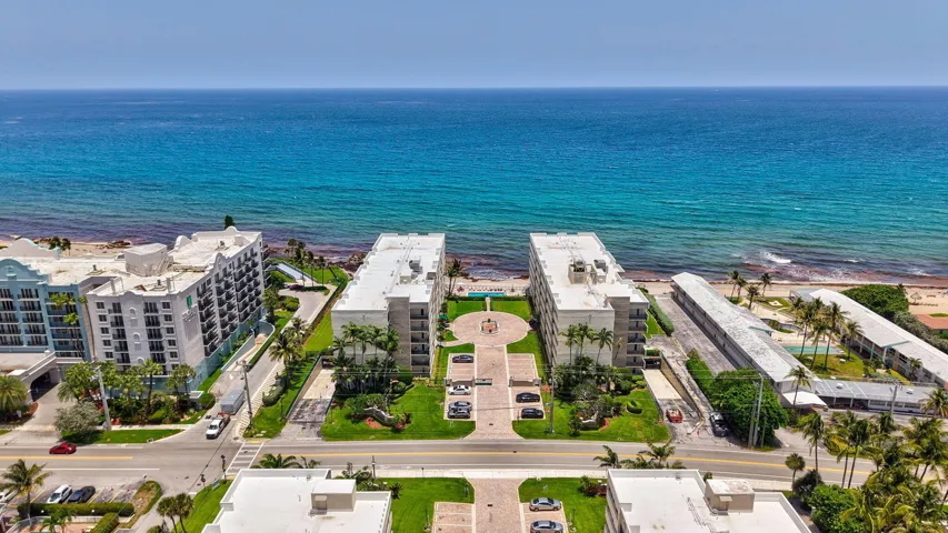 Oceanfront property featuring twin multi-story residential buildings with direct beach access
