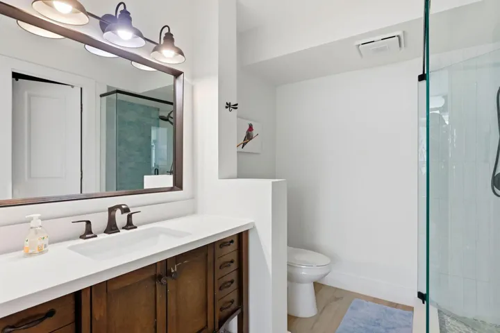 Bathroom featuring a dark wood-finish vanity with a white countertop and rectangular undermount sink