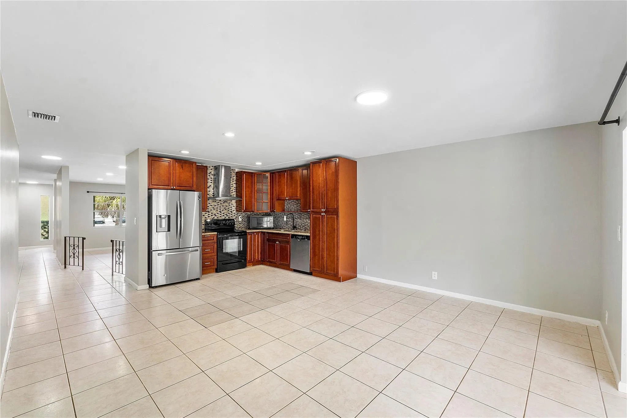 Kitchen featuring wood cabinetry, stainless steel appliances, and a mosaic tile backsplash