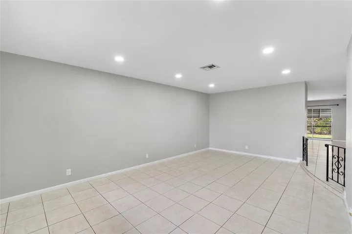 Spacious room with light-colored tile flooring