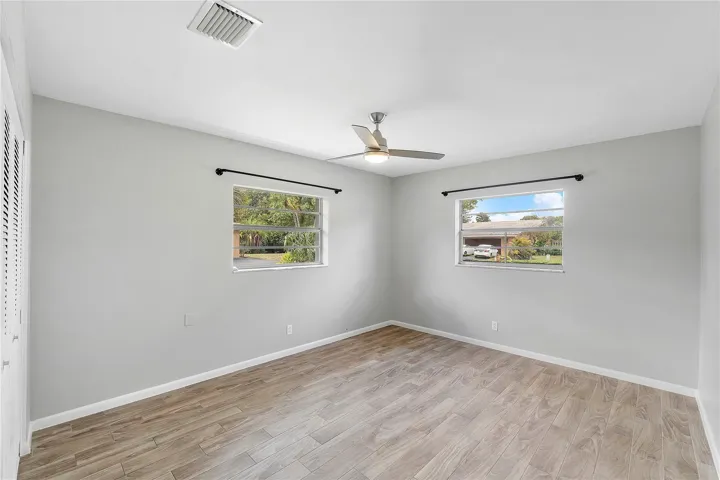 Neutral-toned room featuring wood-finish flooring and light gray walls