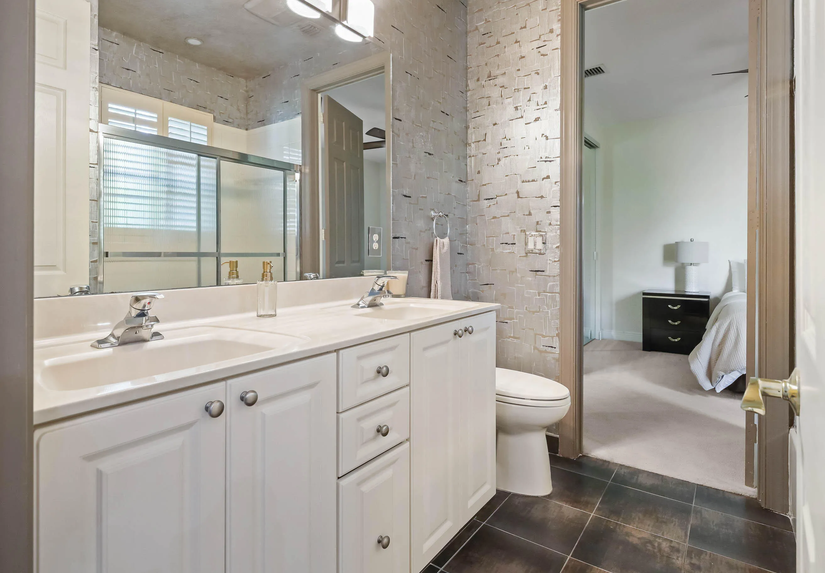 Double vanity with integrated sinks, and white cabinetry