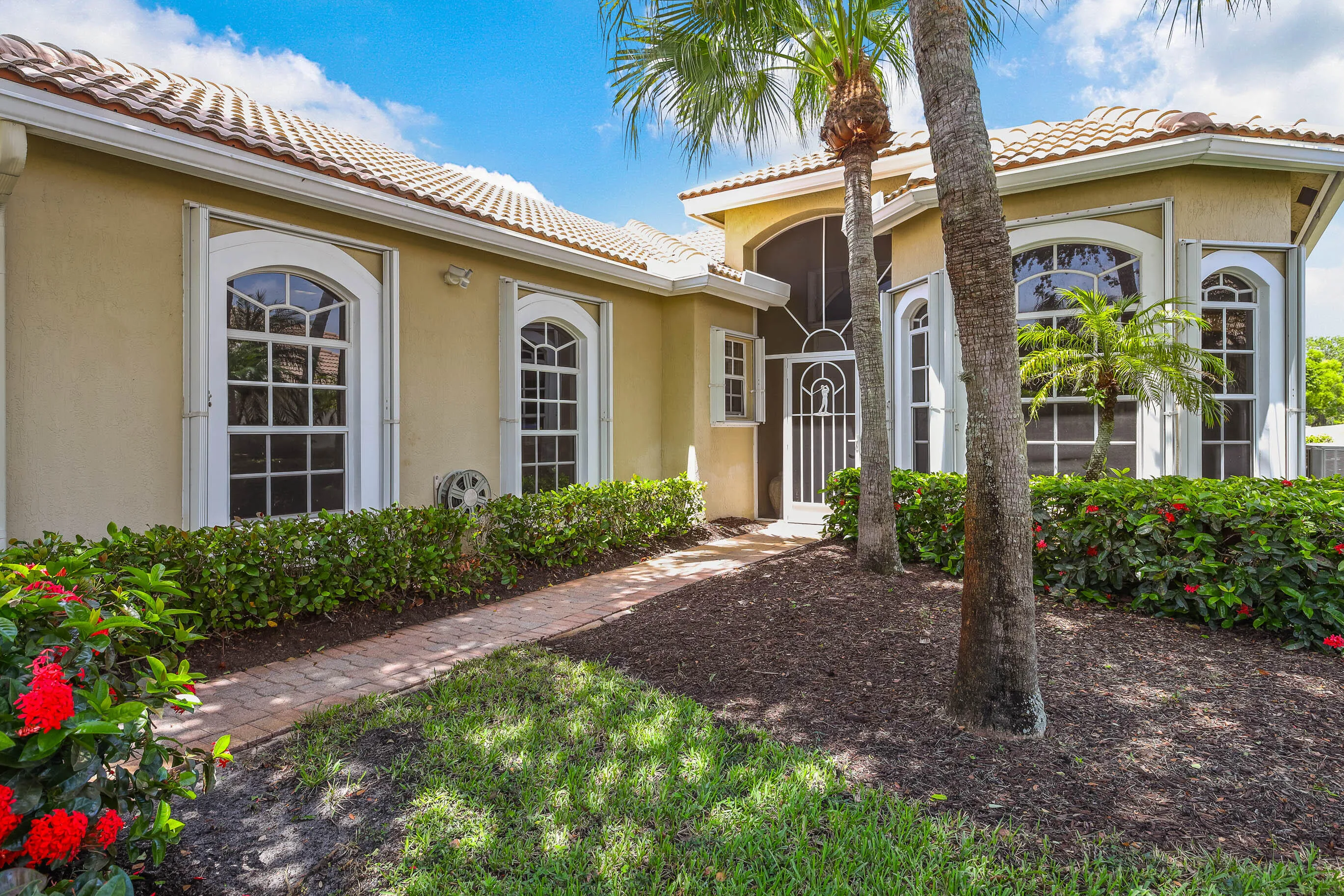 Mediterranean-inspired exterior featuring a tile roof and stucco finish