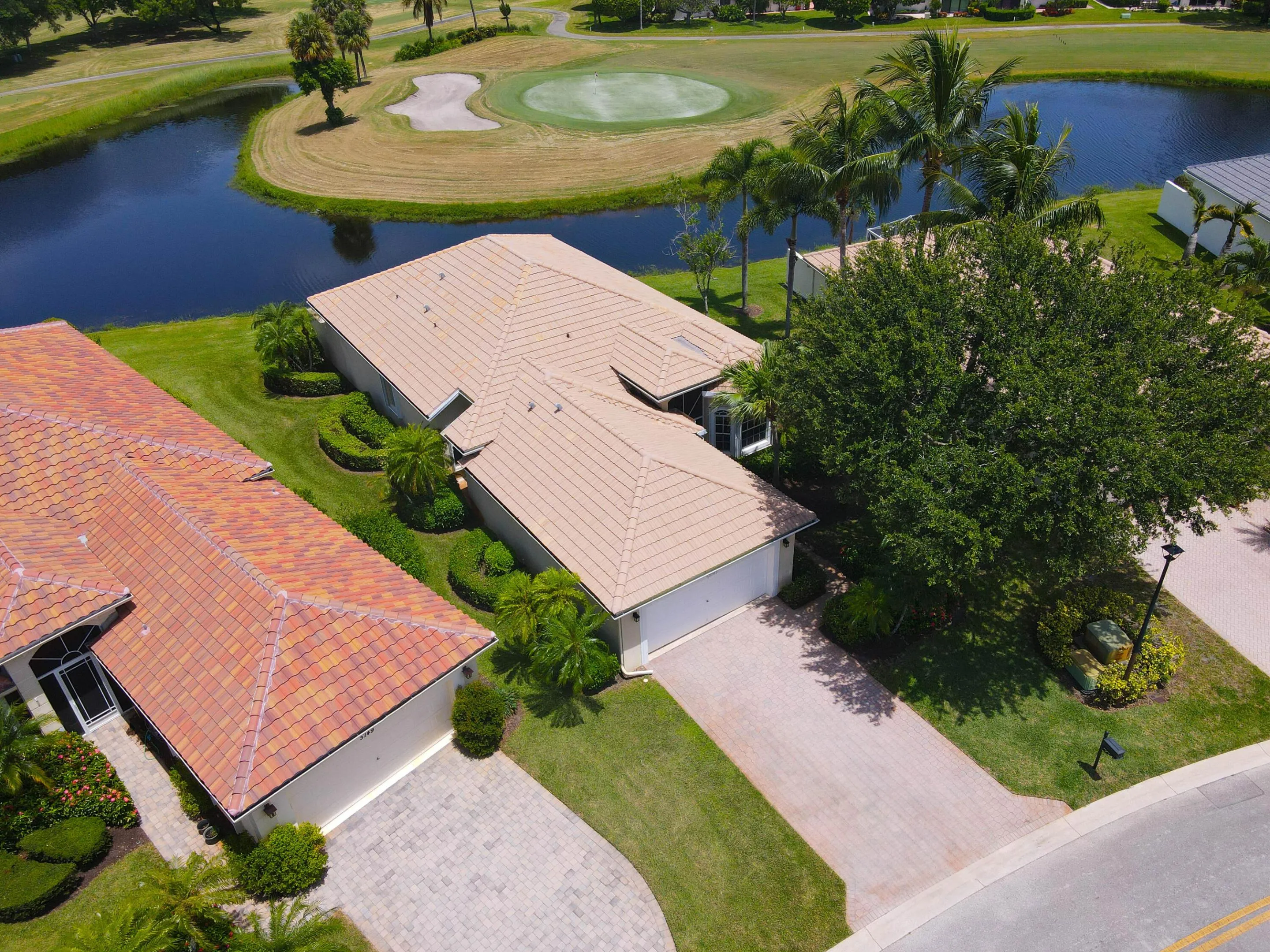 Light-toned tile roof residence with an attached two-car garage