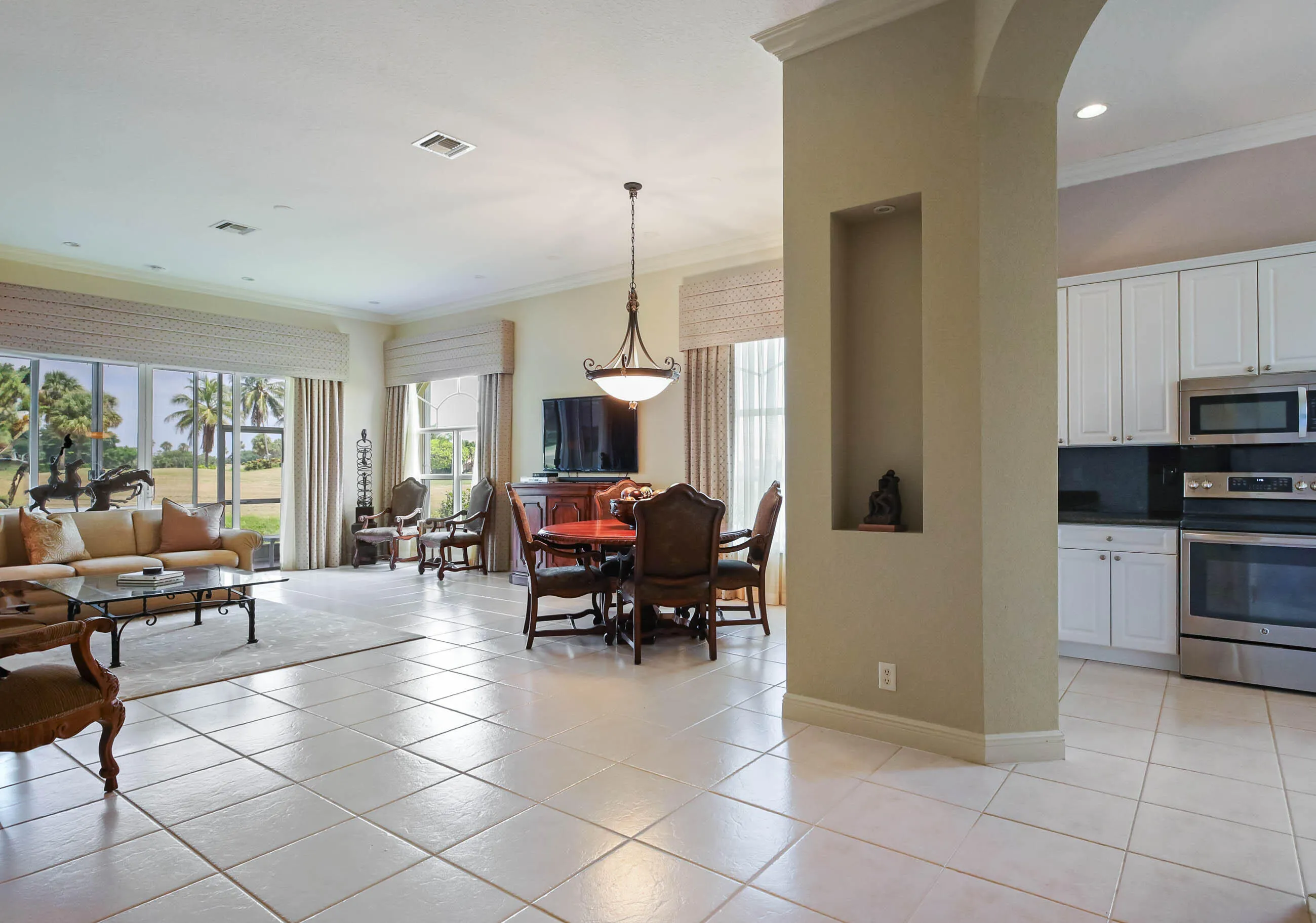 Open-concept living and dining areas featuring tile flooring throughout