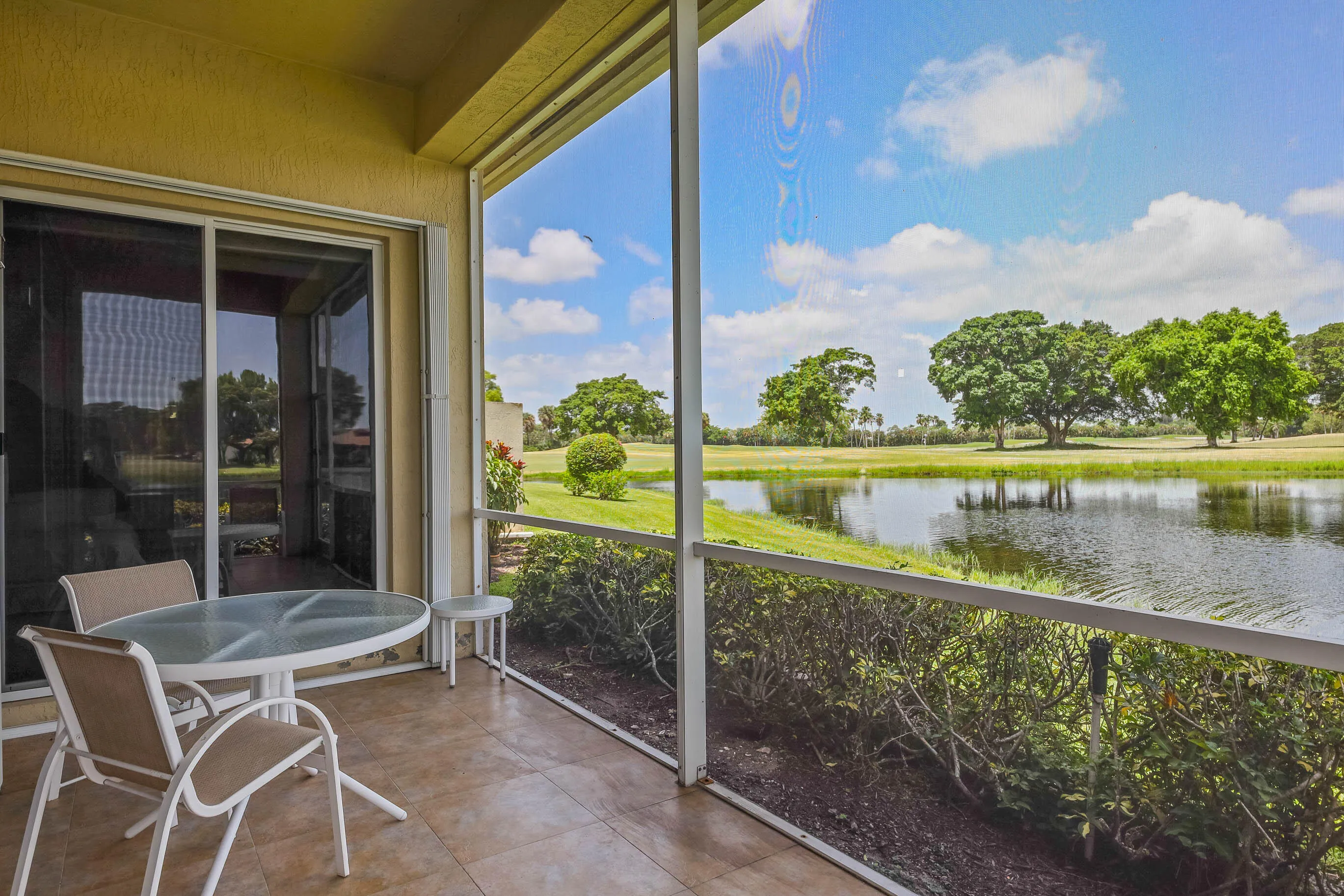 Screened patio featuring tiled flooring and great views