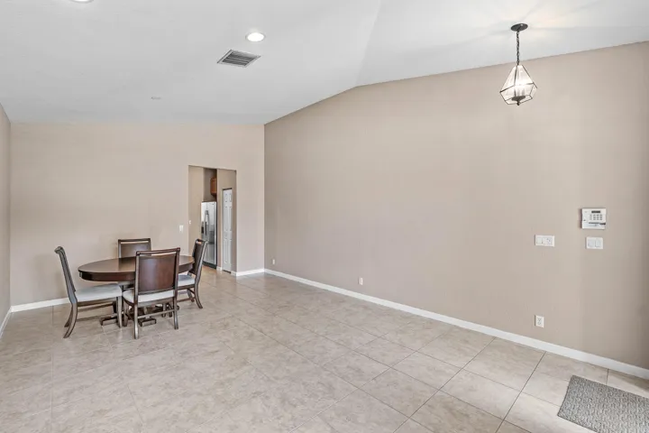 Kitchen featuring granite countertops, stainless steel appliances, tile flooring, recessed lighting, and wood cabinetry