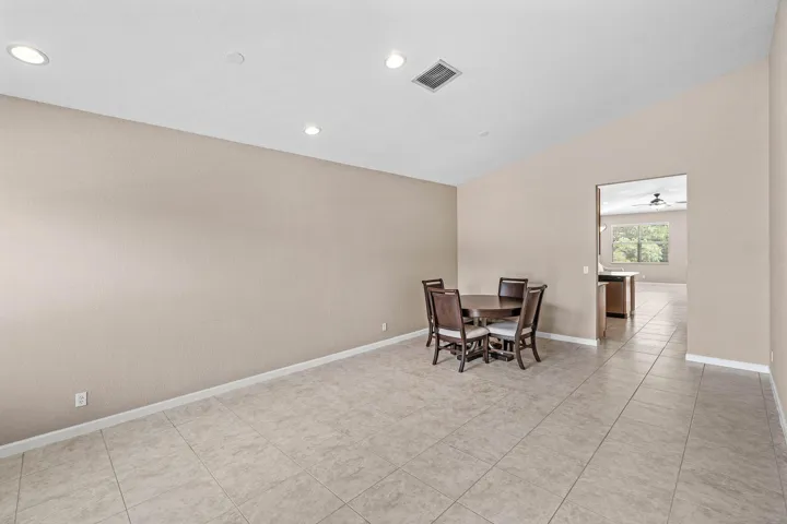 Open-concept kitchen featuring wood cabinetry, granite-finish countertops, and stainless steel appliances