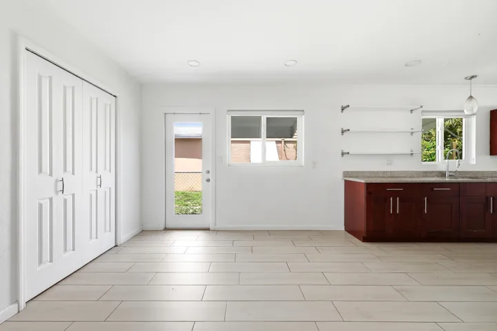 Bright interior featuring light-toned tile flooring, white walls, and recessed lighting