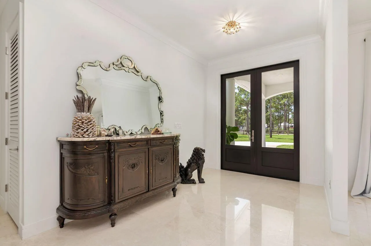Double entry doors with glass panels and dark wood framing