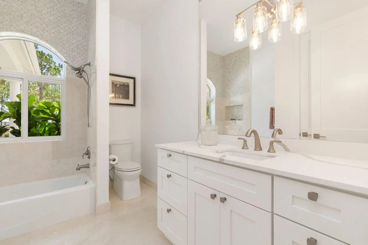 Vanity area featuring a dual sink with a white countertop and brushed nickel fixtures