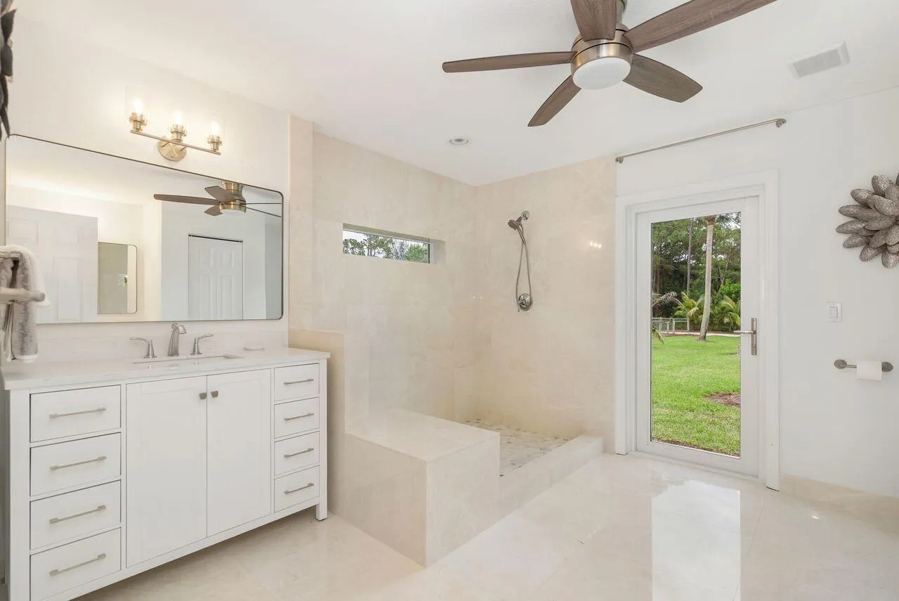 Contemporary Primary bathroom featuring a spacious walk-in shower with a built-in bench and a horizontal privacy window