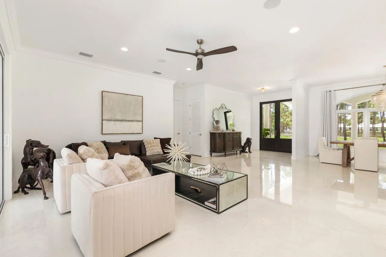 Expansive living area with high ceilings, recessed lighting.
