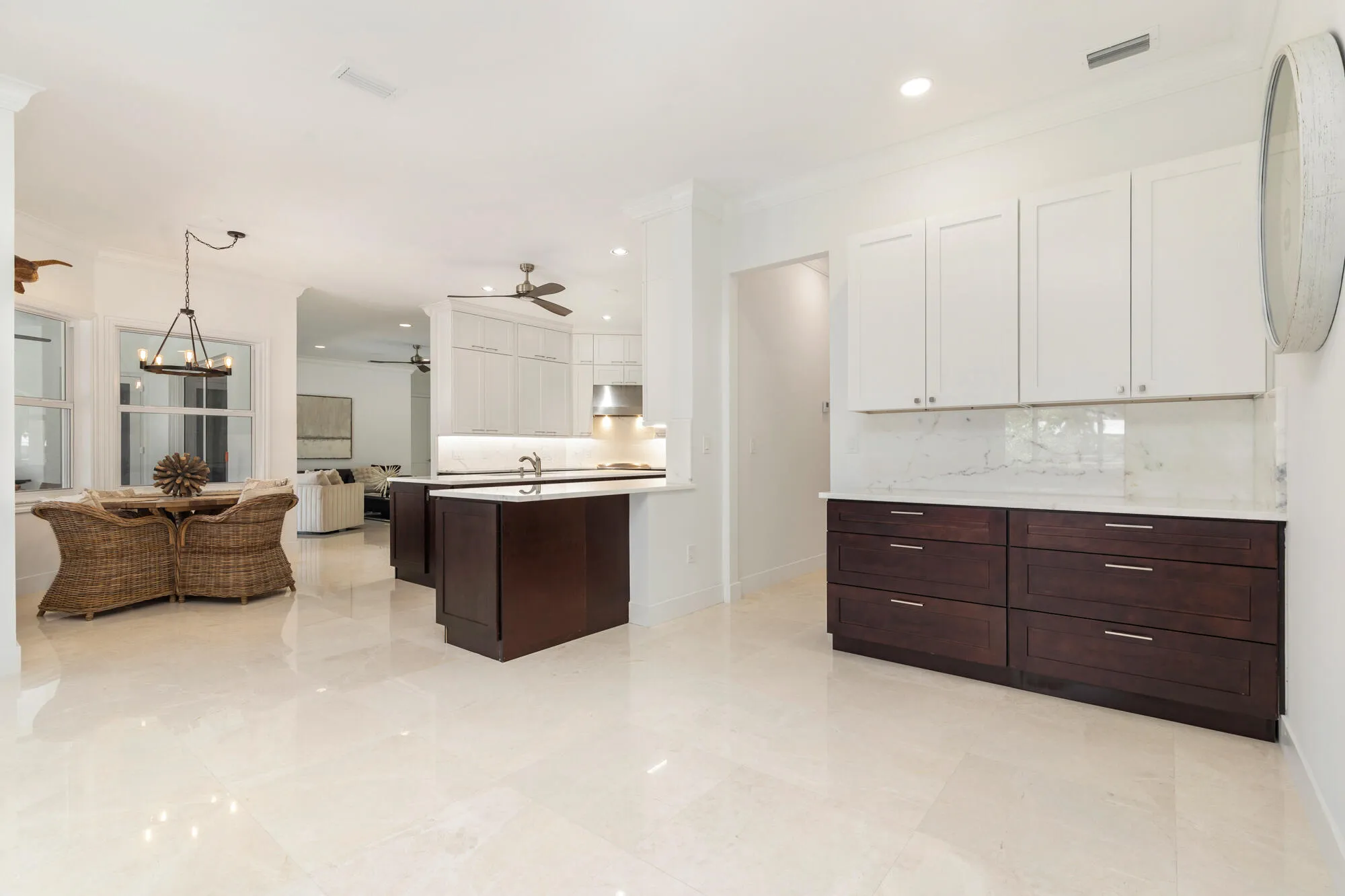 Spacious kitchen and dining area, extended area for a coffee bar or serving area with an abundance of cabinets, recessed lighting, and a kitchen island with an undermount sink