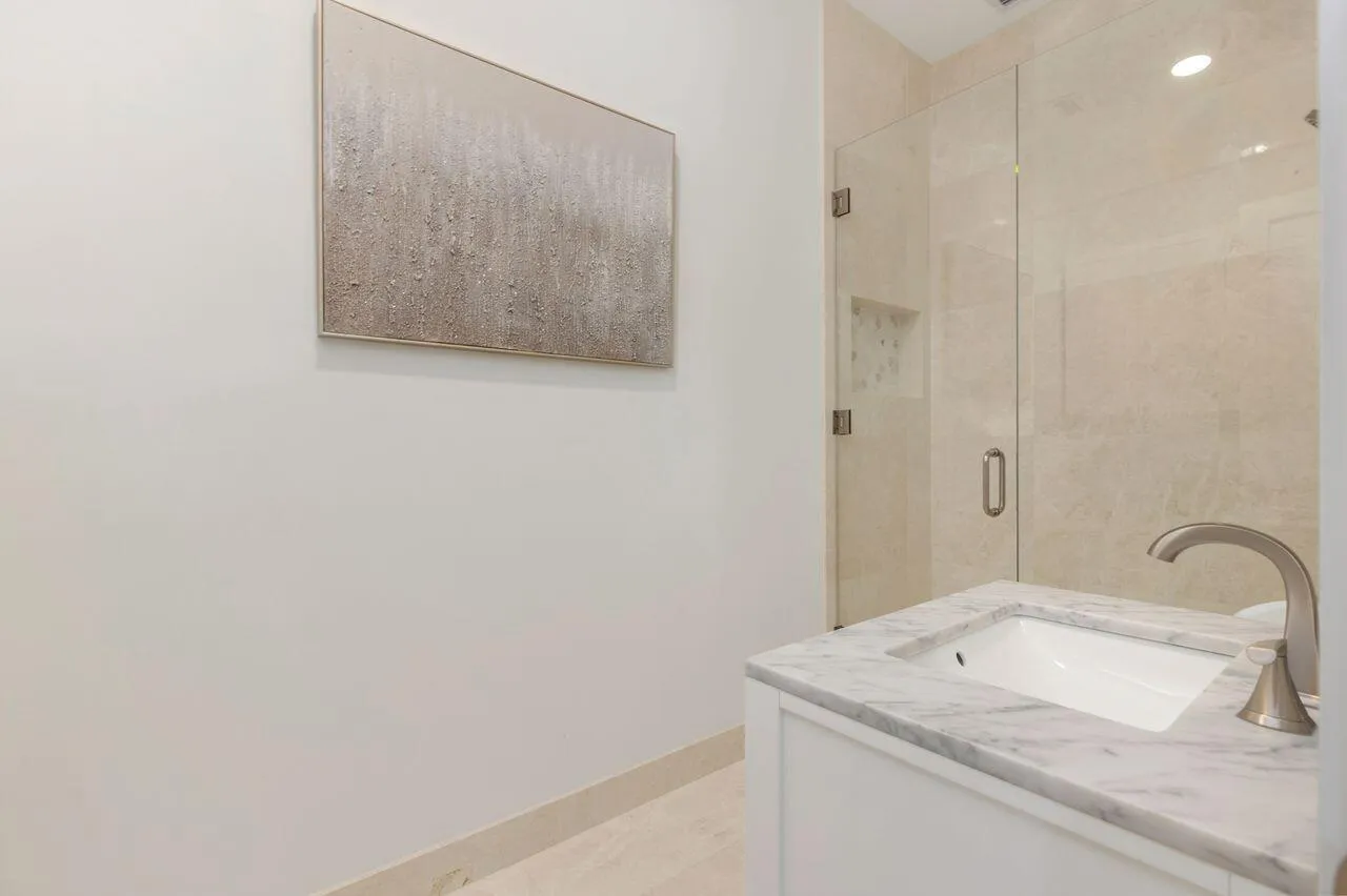 Guest Bathroom, white vanity with a marble countertop and undermount sink