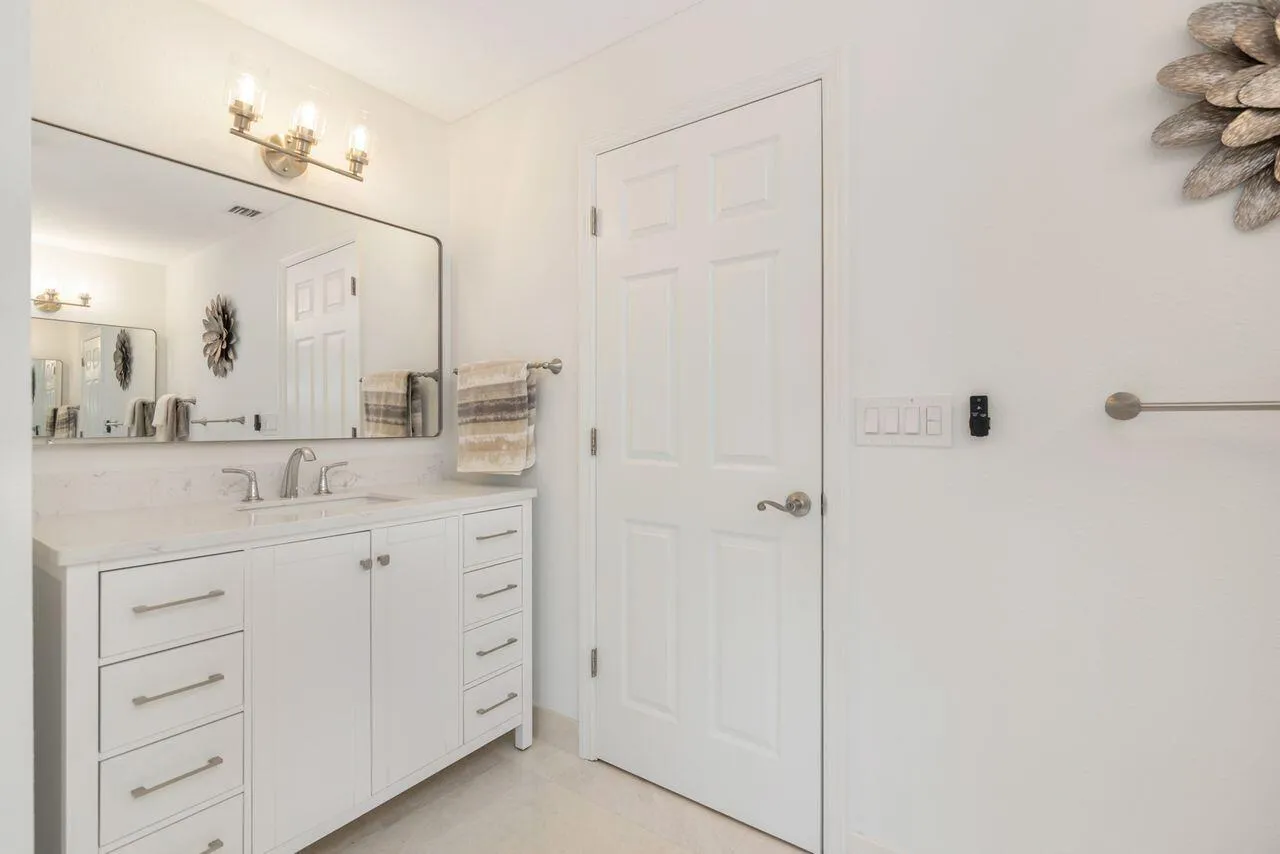 Vanity featuring a single undermount sink with a chrome faucet