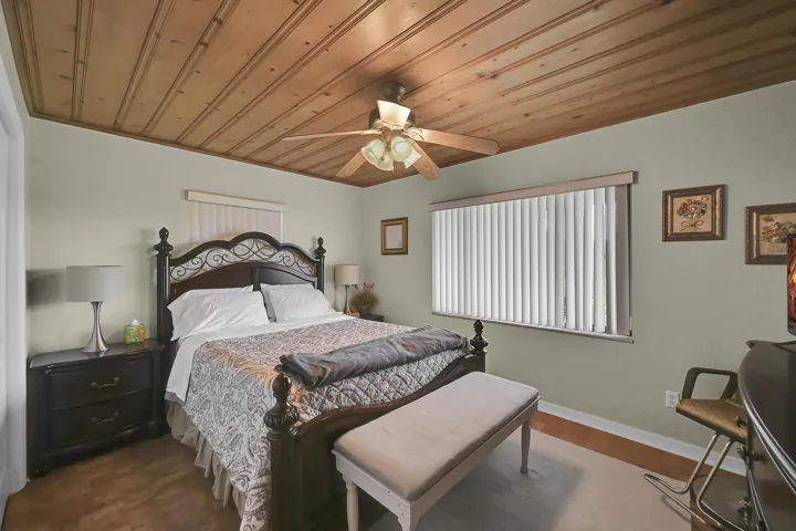 Wood-plank ceiling with a ceiling fan light fixture