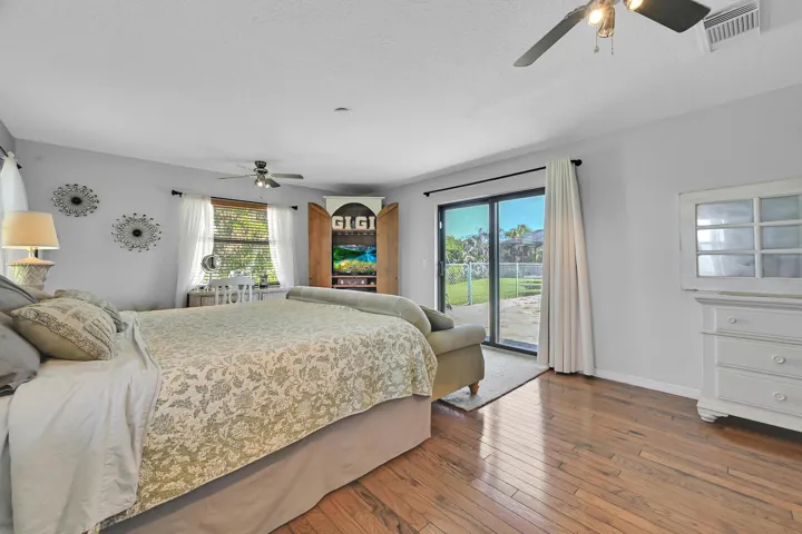 Spacious interior featuring wood-finish flooring and a ceiling fan