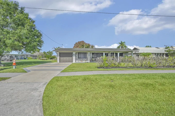 Single-story residence featuring a concrete driveway and an attached two-car garage