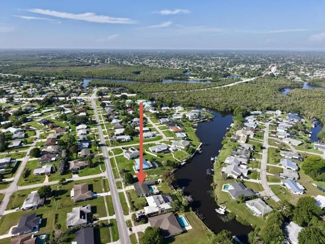 Aerial perspective showcasing a residential neighborhood with canal access