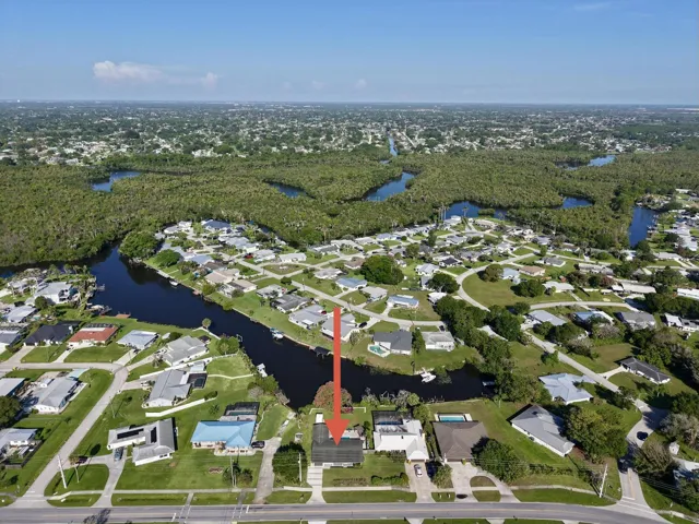 Aerial perspective showcasing a residential area with canal access and surrounding green spaces