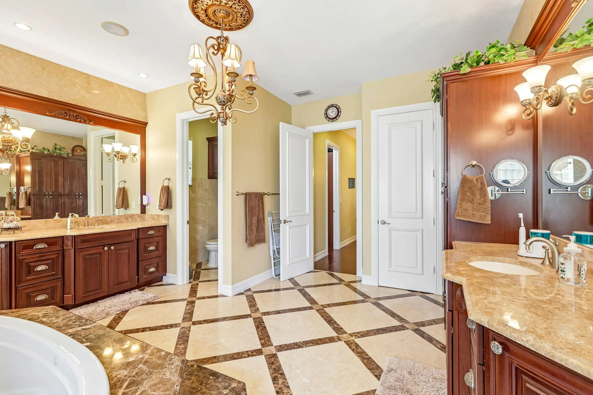 Spacious bathroom featuring diagonal tile flooring with contrasting marble accents
