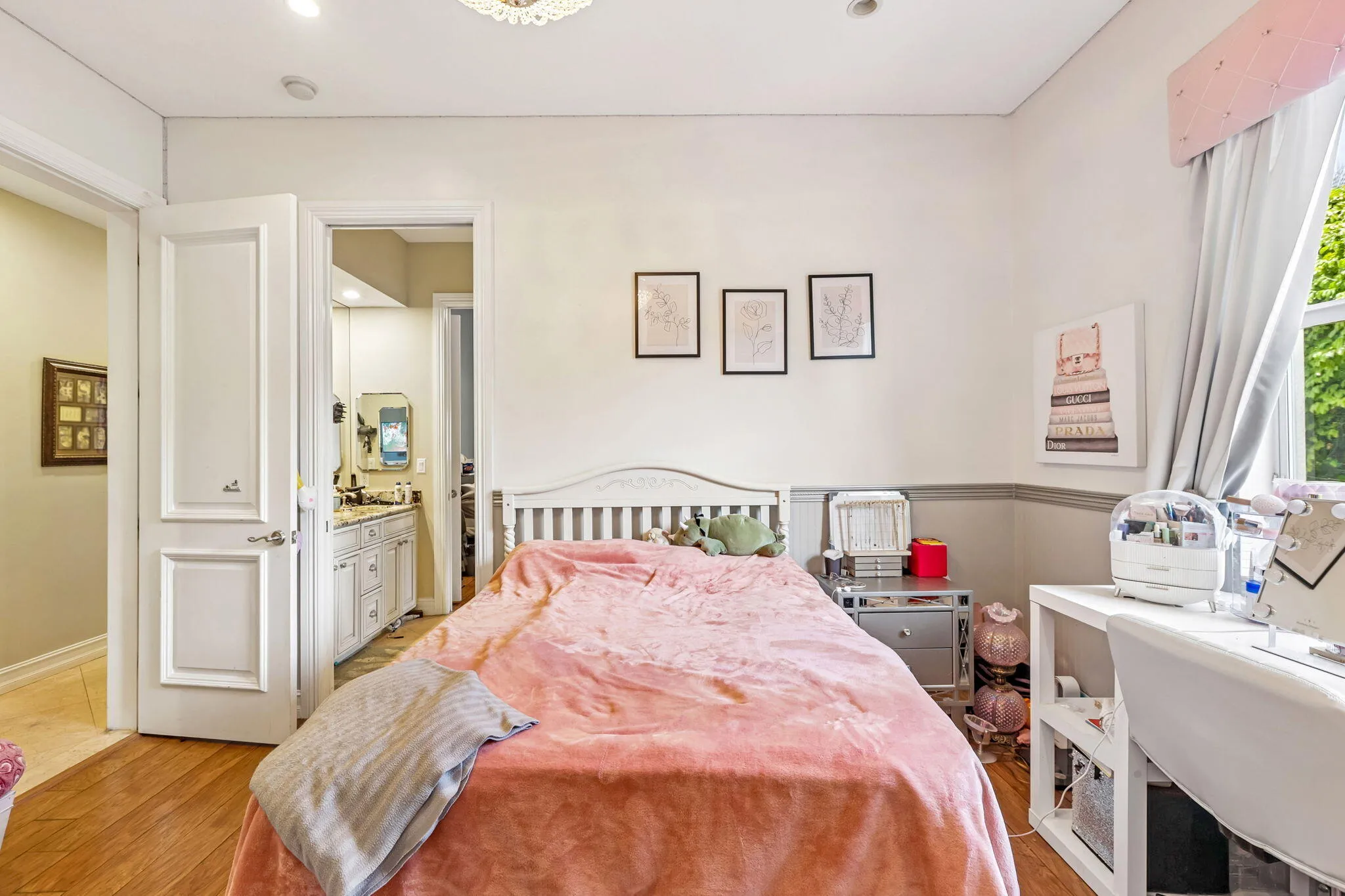 Bedroom featuring wood-finish flooring, two-tone wall treatment, and a recessed ceiling light