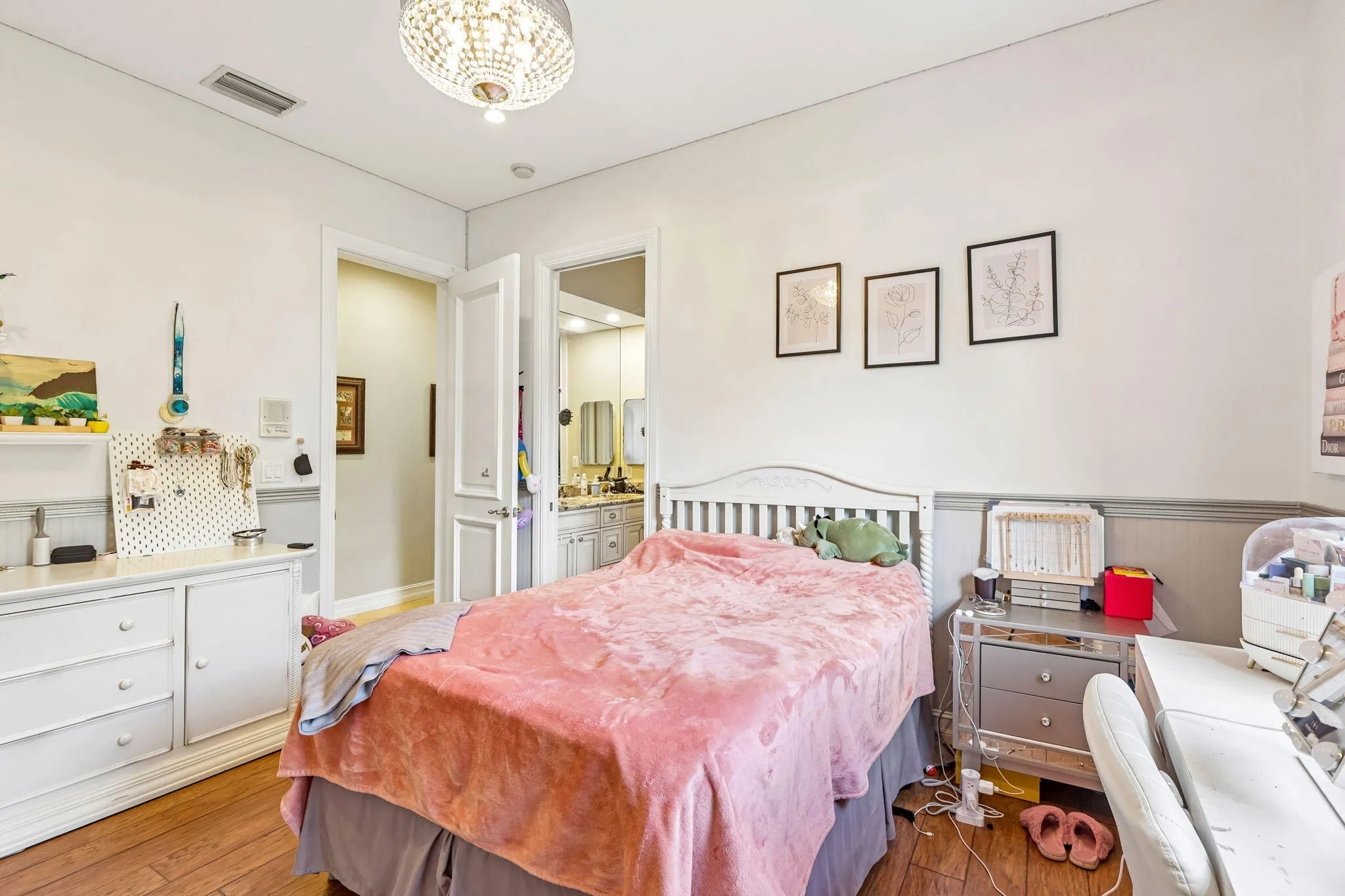 Bedroom featuring wood-finish flooring and a crystal chandelier