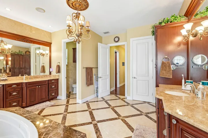 Spacious bathroom featuring diagonal tile flooring with contrasting marble accents
