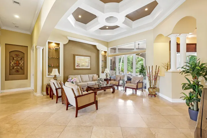 Spacious interior with an octagonal coffered ceiling, recessed lighting, and large format floor tile