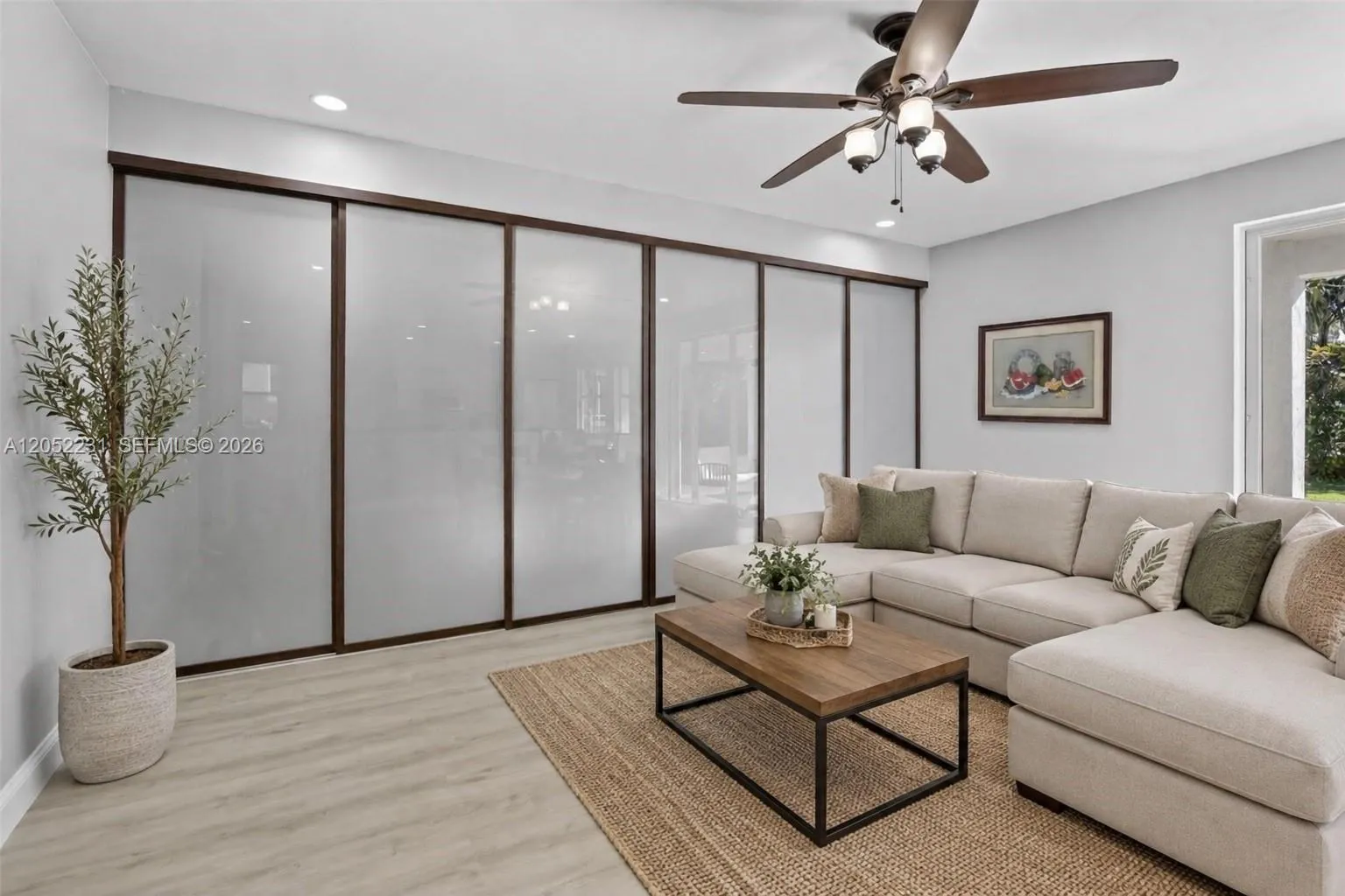 Family room with glass wall-opens to 5th bedroom/office/ exercise room on the 1st flr