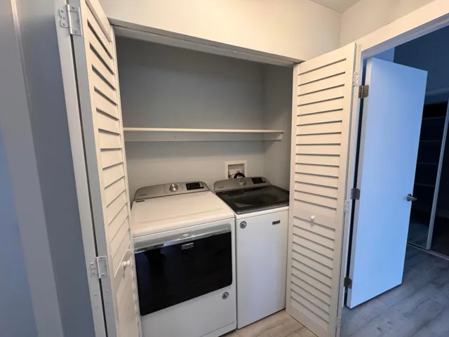 WAHER AND DRYER MYTAC ON HALLWAY CLOSET