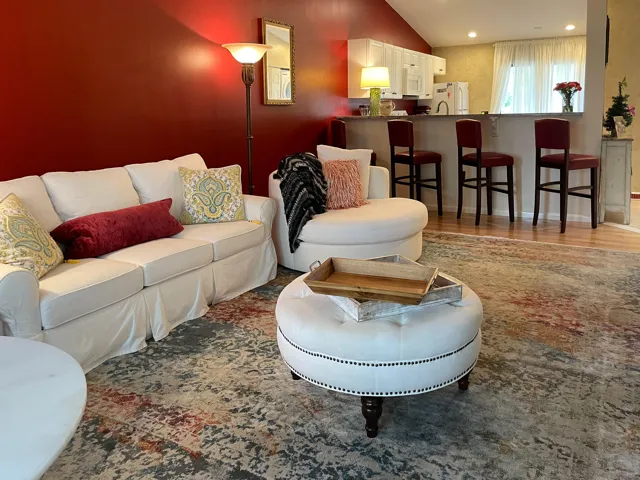 Open-concept living space featuring a partial kitchen pass-through, vaulted ceiling, and recessed lighting