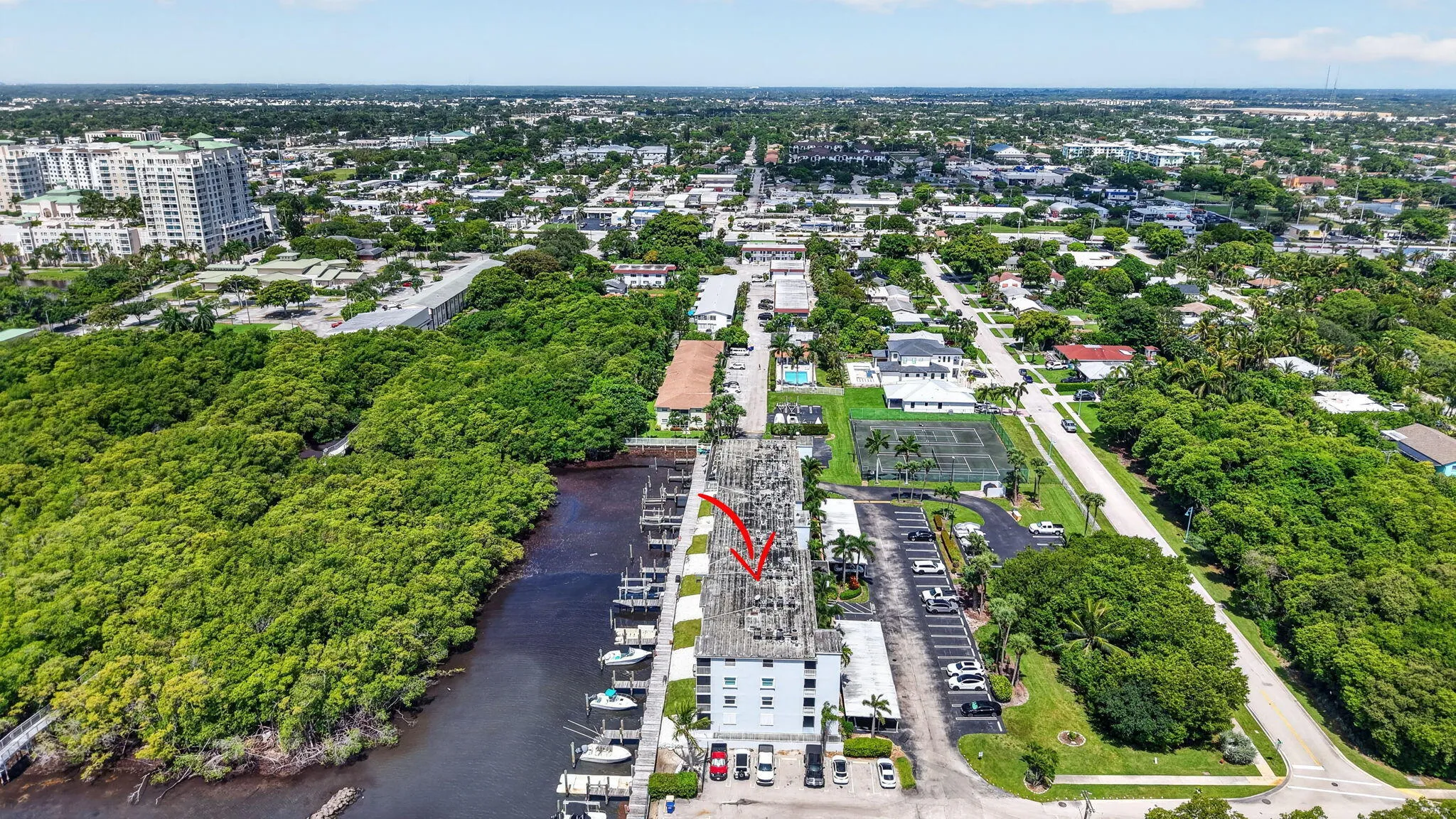 Waterfront property featuring extensive dockage, a multi-story building, and a paved parking area