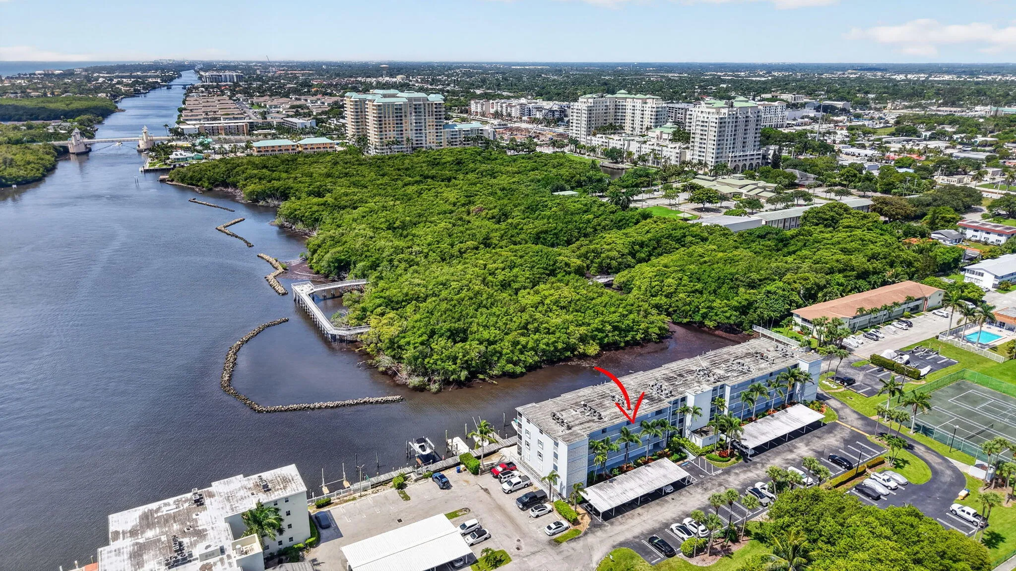 Waterfront multi-story building featuring a flat roof and multiple balconies