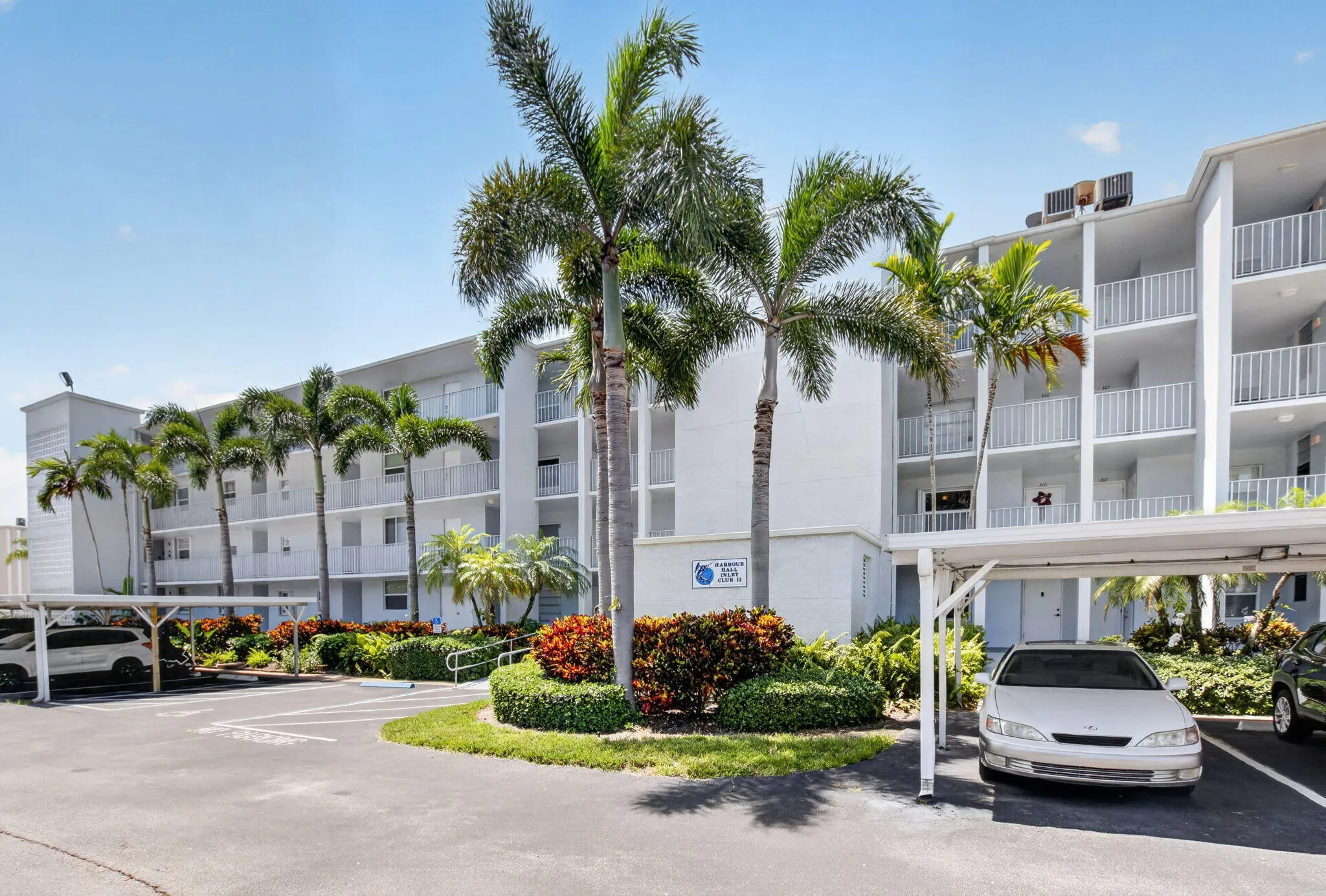 Multi-story residential building featuring private balconies with white railings