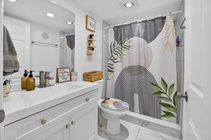 White vanity with an integrated rectangular sink and polished chrome hardware