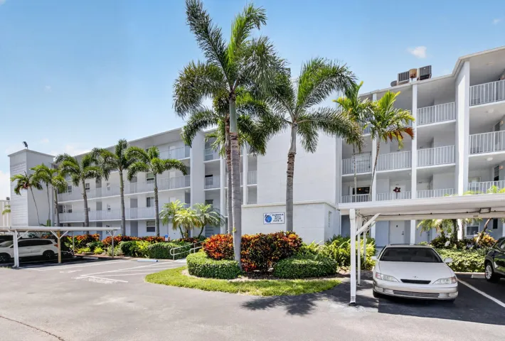 Multi-story residential building featuring private balconies with white railings