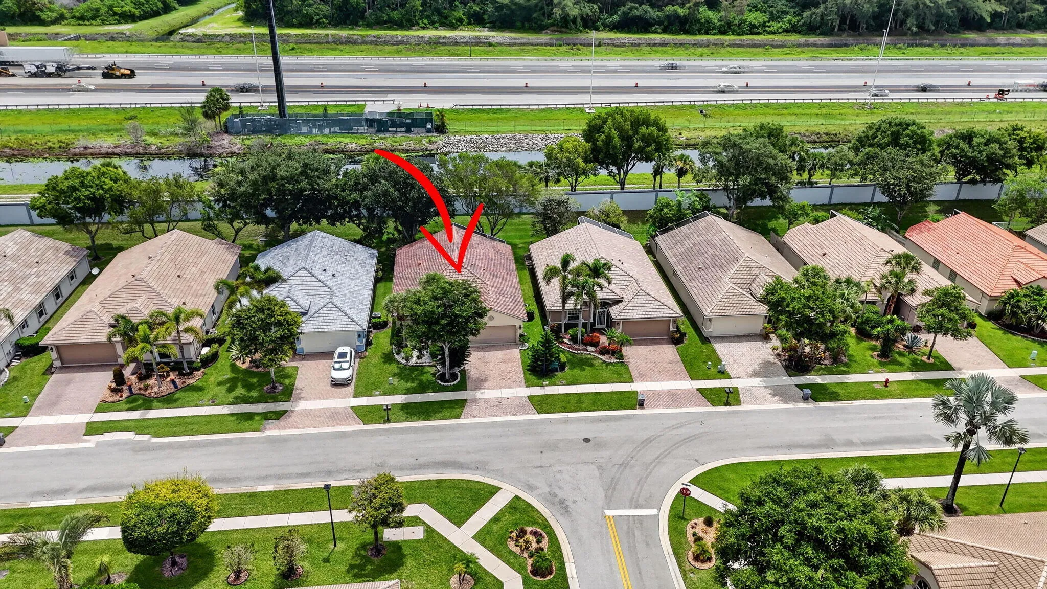 Aerial perspective of a residential property featuring a tiled roof and an attached garage