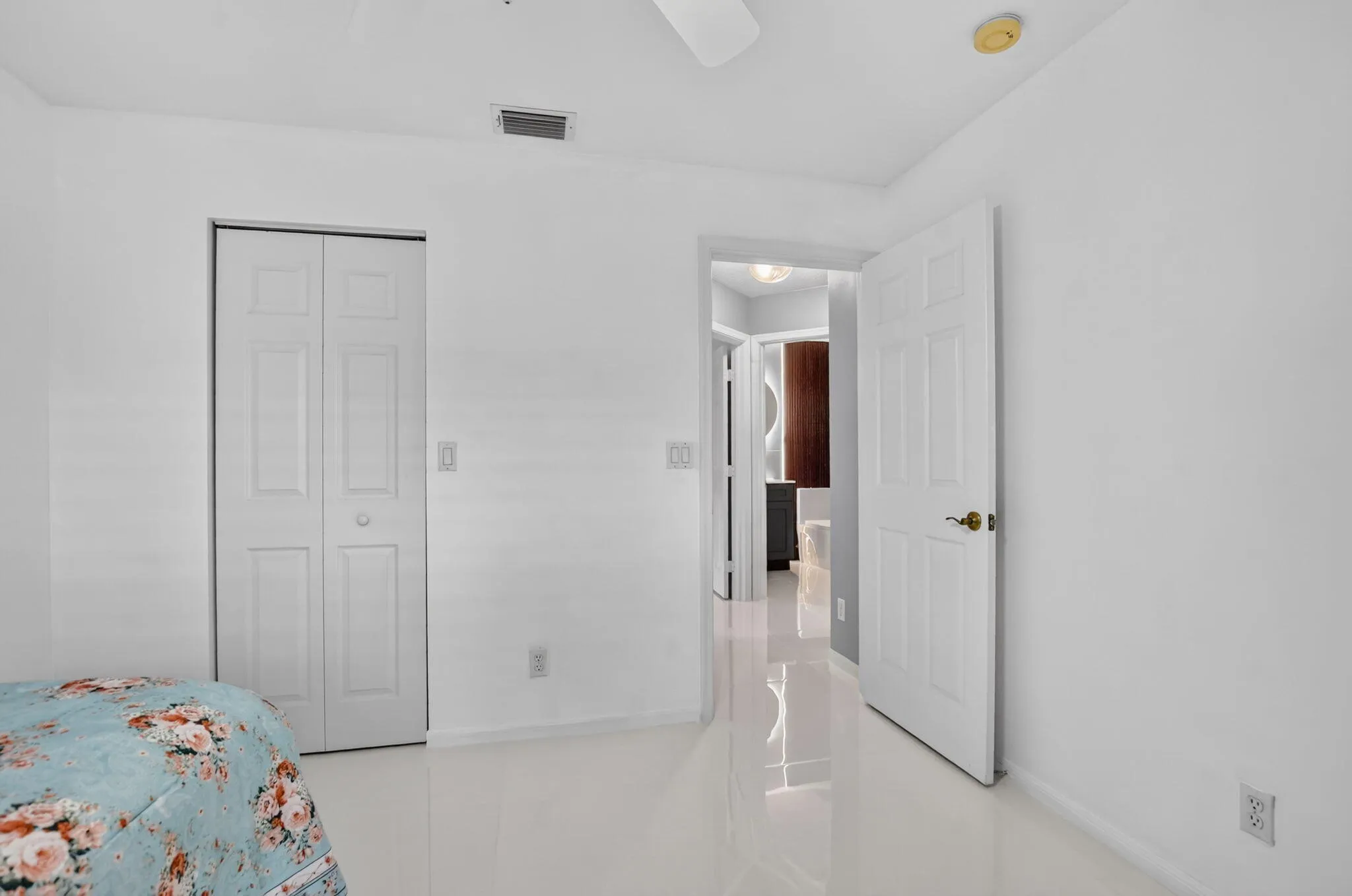 White interior walls and glossy tile flooring