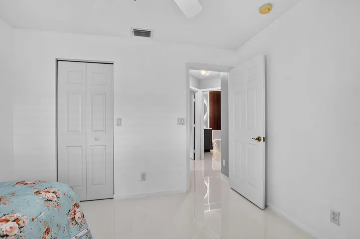 White interior walls and glossy tile flooring