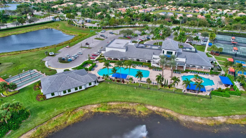 Community clubhouse featuring two swimming pools, multiple tennis courts, and bocce ball courts