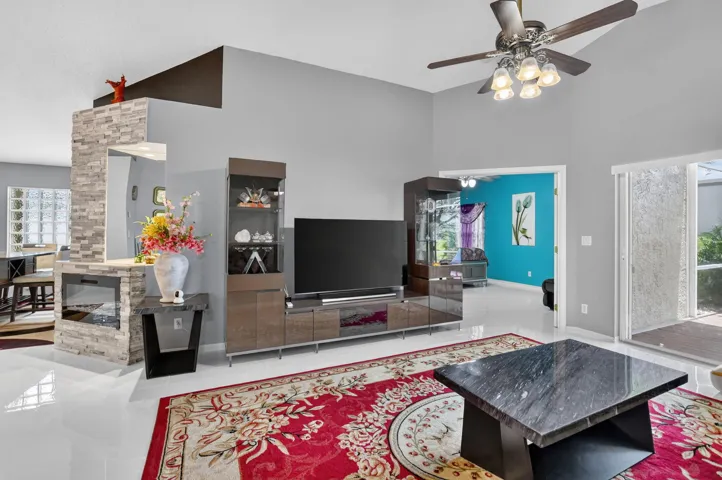 Vaulted ceilings featuring a ceiling fan with integrated lighting