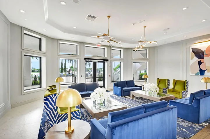 Spacious common area featuring recessed lighting, a coffered ceiling, multiple windows, double glass-paneled entry doors, and durable tile flooring