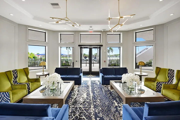 Lobby featuring floor-to-ceiling windows, modern chandeliers, recessed lighting, and crown molding