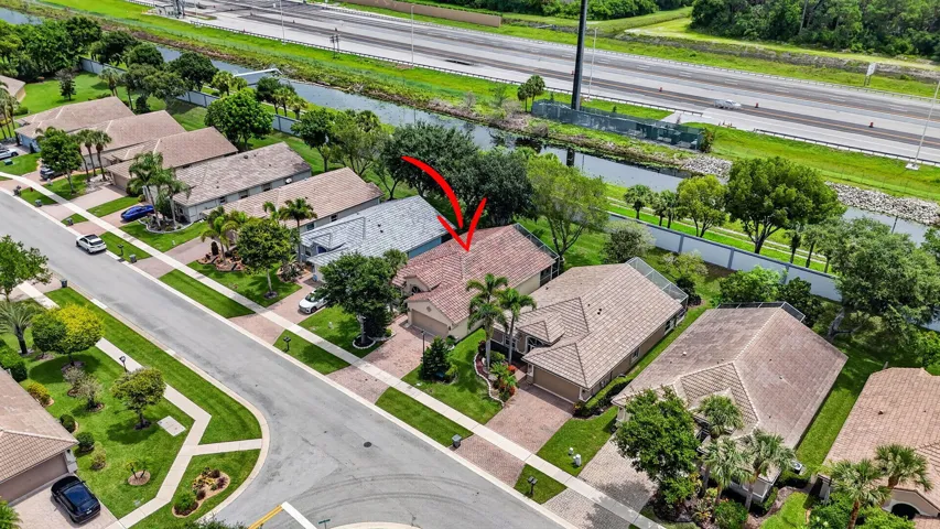 Aerial perspective of a residential neighborhood featuring a property with a tiled roof
