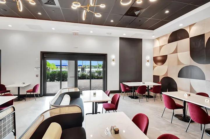 Spacious interior featuring a decorative wall panel, recessed lighting, and a dark tile ceiling